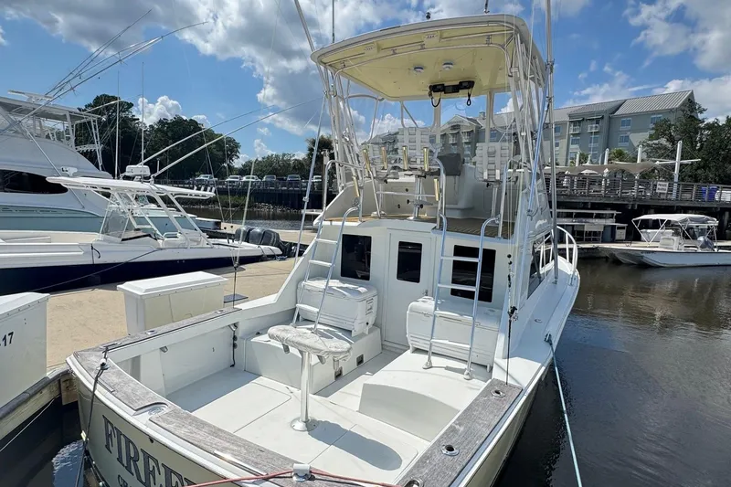 Slide: The Image of 1975 Chris Craft 30 Tournament SF boat docked at marina under blue sky. - 2