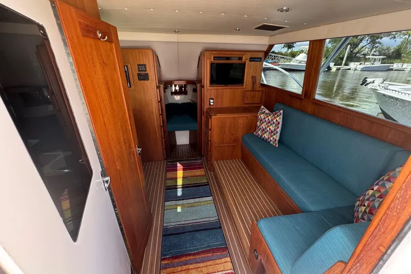 Slide: The Image of Interior of 1975 Chris Craft 30 Tournament SF with wood paneling and blue seating. - 21