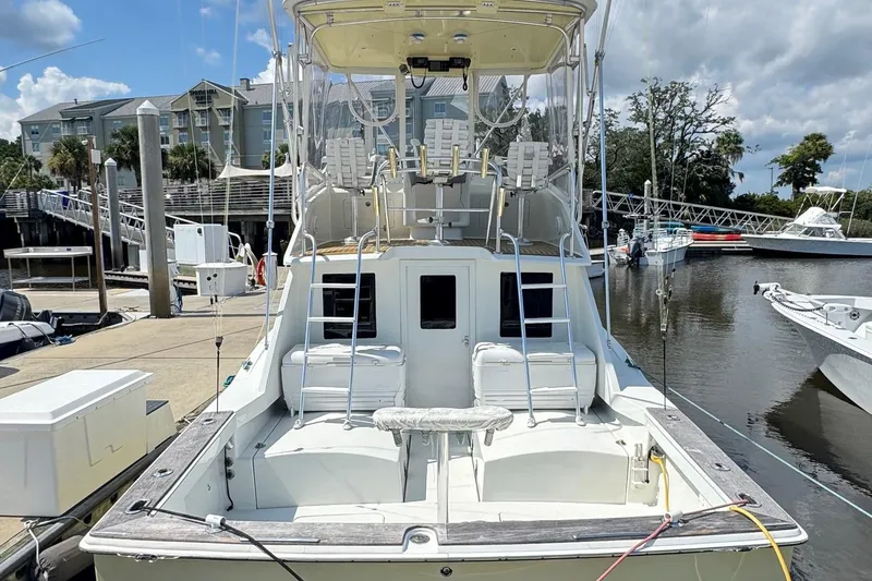Slide: The Image of 1975 Chris Craft 30 Tournament SF docked at marina, showcasing spacious deck and fishing setup. - 3
