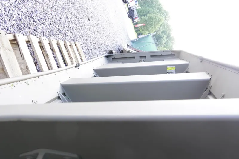 Slide: The Image of 2026 G3 Gator Tough 1236 boat interior with metal framework and gravel background. - 12