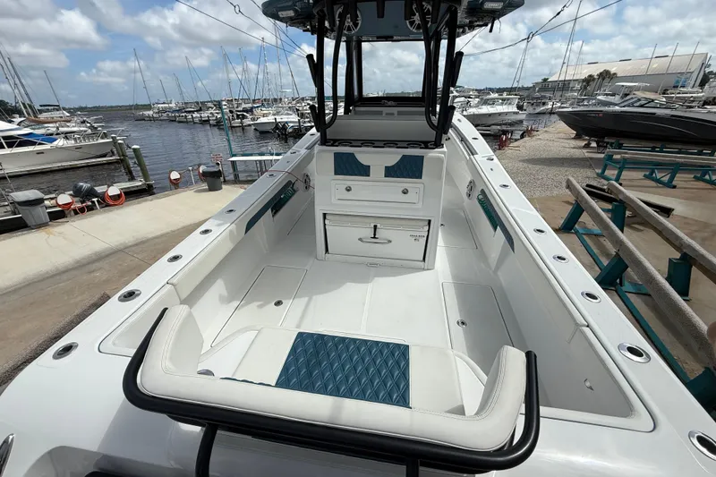 Slide: The Image of 2023 Front Runner 33 CC boat interior at marina, showcasing seating and storage features. - 14
