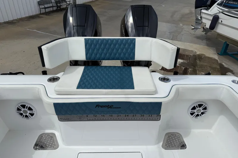 Slide: The Image of 2023 Front Runner 33 CC boat interior with blue and white seating and dual engines. - 15