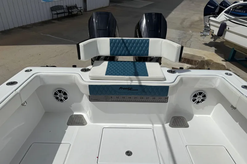 Slide: The Image of 2023 Front Runner 33 CC boat interior with seating and dual engines. - 16