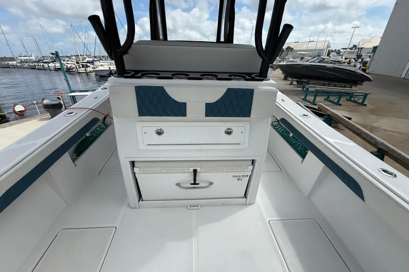 Slide: The Image of 2023 Front Runner 33 CC boat interior with storage and rod holders at marina. - 19