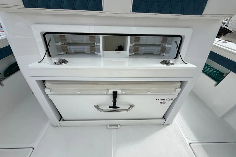 Slide: The Image of 2023 Front Runner 33 CC boat storage area with cooler and compartments. - 20