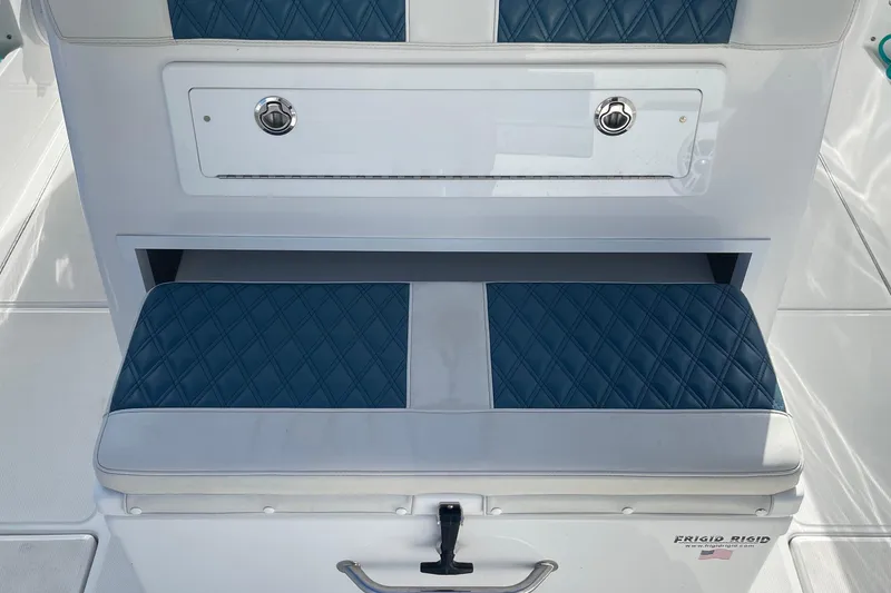 Slide: The Image of 2023 Front Runner 33 CC boat seat with blue diamond-patterned upholstery and storage compartment. - 21