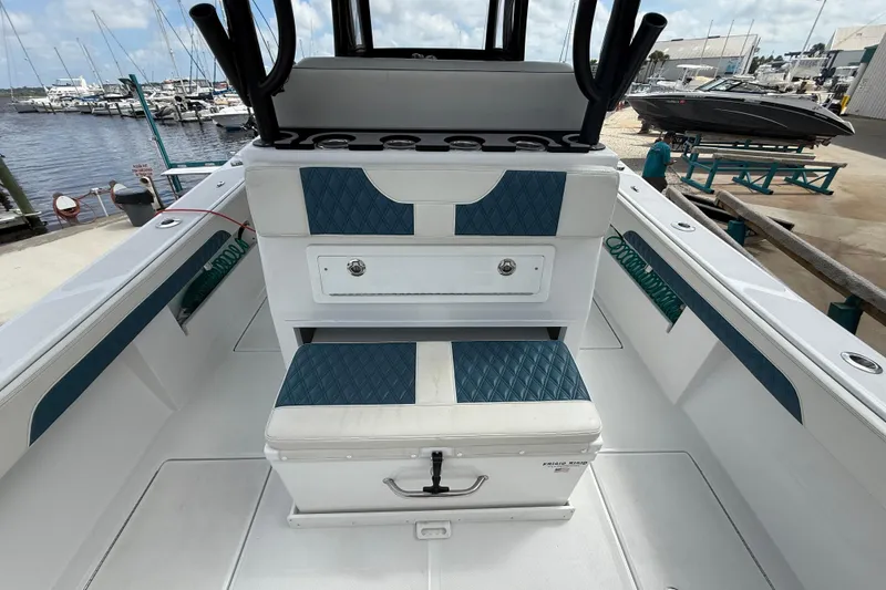Slide: The Image of 2023 Front Runner 33 CC boat interior with blue and white seating at marina. - 22
