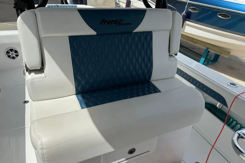 Slide: The Image of 2023 Front Runner 33 CC boat seat with blue and white upholstery. - 25