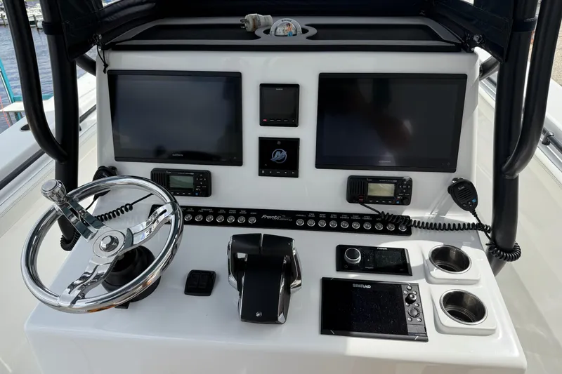 Slide: The Image of 2023 Front Runner 33 CC boat dashboard with advanced navigation and control systems. - 27
