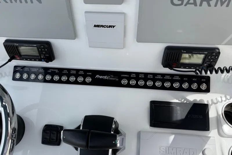 Slide: The Image of Control panel of 2023 Front Runner 33 CC boat with various switches and displays. - 33