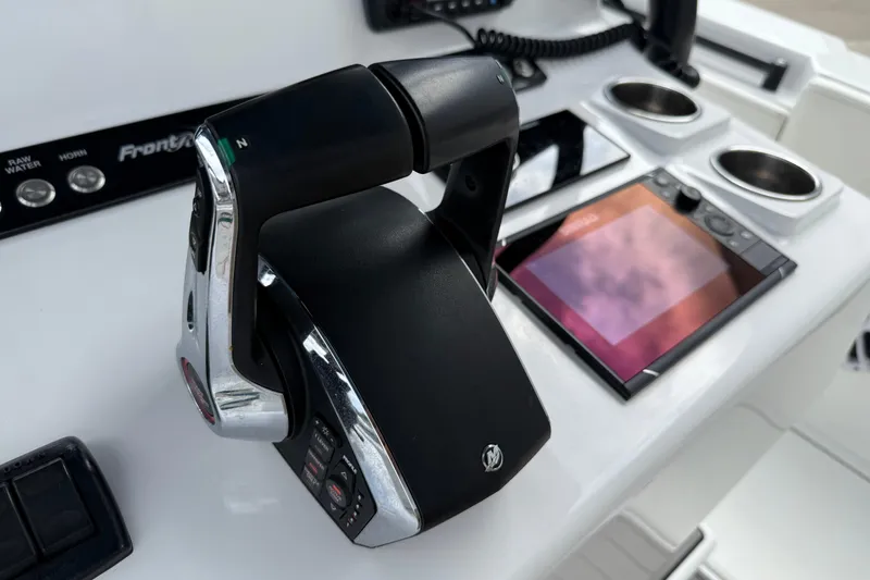 Slide: The Image of Control panel of 2023 Front Runner 33 CC boat with throttle and display. - 34