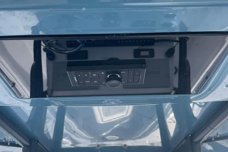 Slide: The Image of Control panel of 2023 Front Runner 33 CC boat, featuring navigation and menu buttons. - 36