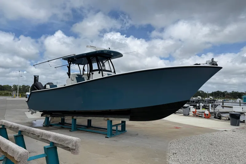 Slide: The Image of 2023 Front Runner 33 CC boat on display at a marina under cloudy skies. - 4