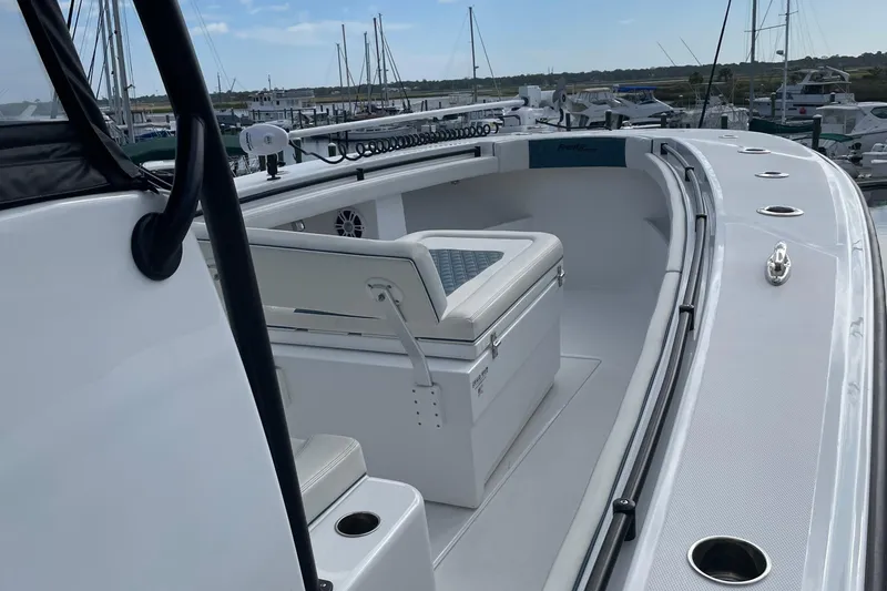 Slide: The Image of 2023 Front Runner 33 CC boat interior with seating and storage, docked at marina. - 40