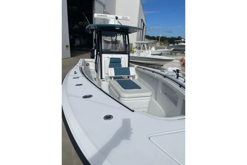 Slide: The Image of 2023 Front Runner 33 CC boat with Garmin equipment, docked near a storage facility. - 41