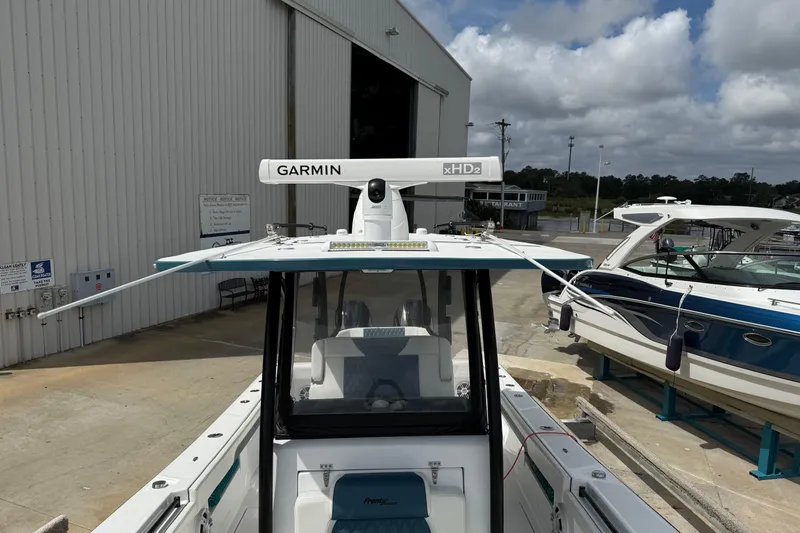 Slide: The Image of 2023 Front Runner 33 CC boat with Garmin xHD2 radar, docked near other boats. - 42