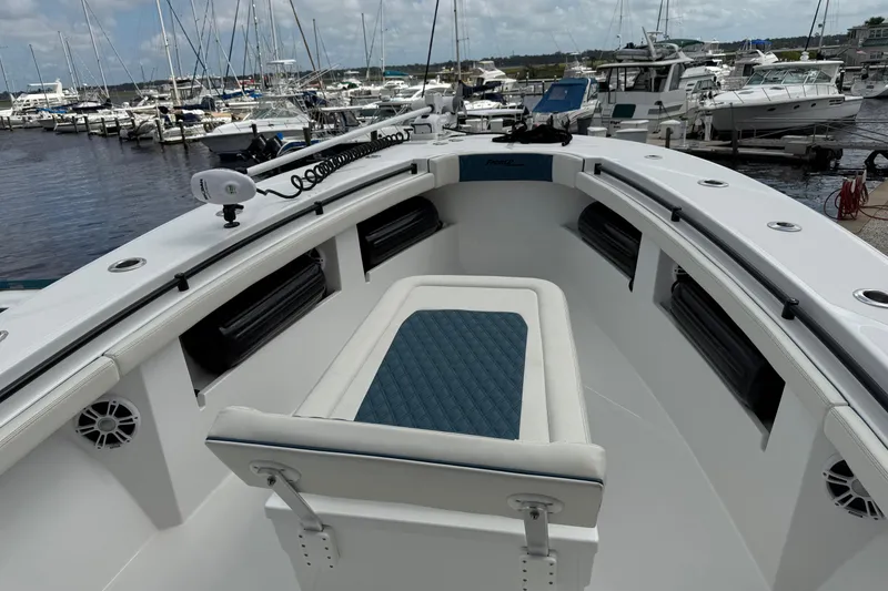 Slide: The Image of 2023 Front Runner 33 CC boat interior at marina, showcasing seating and equipment. - 45