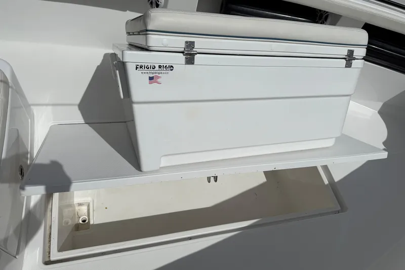 Slide: The Image of Frigid Rigid cooler on 2023 Front Runner 33 CC boat with storage compartment. - 46