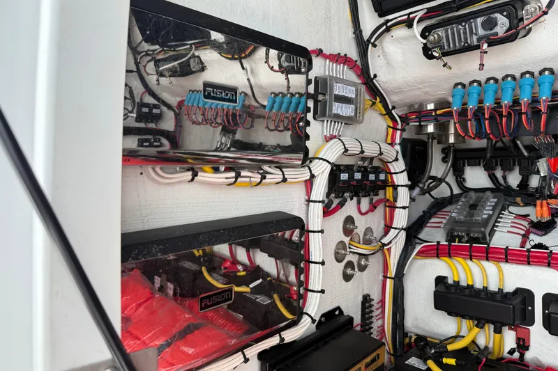 Slide: The Image of Electrical wiring system inside 2023 Front Runner 33 CC boat, featuring organized cables and components. - 48
