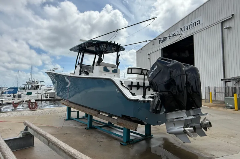 Slide: The Image of 2023 Front Runner 33 CC boat at Palm Cove Marina, featuring dual Mercury engines. - 7