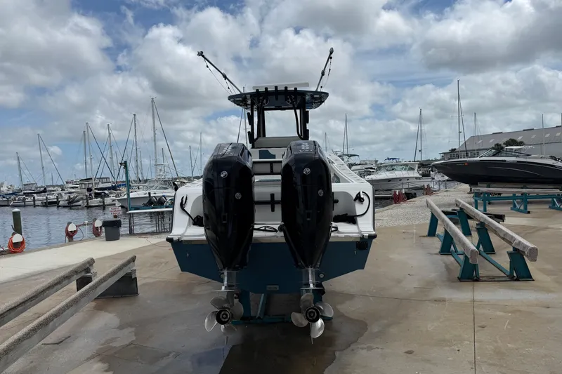 Slide: The Image of 2023 Front Runner 33 CC boat with dual engines at a marina dock. - 8
