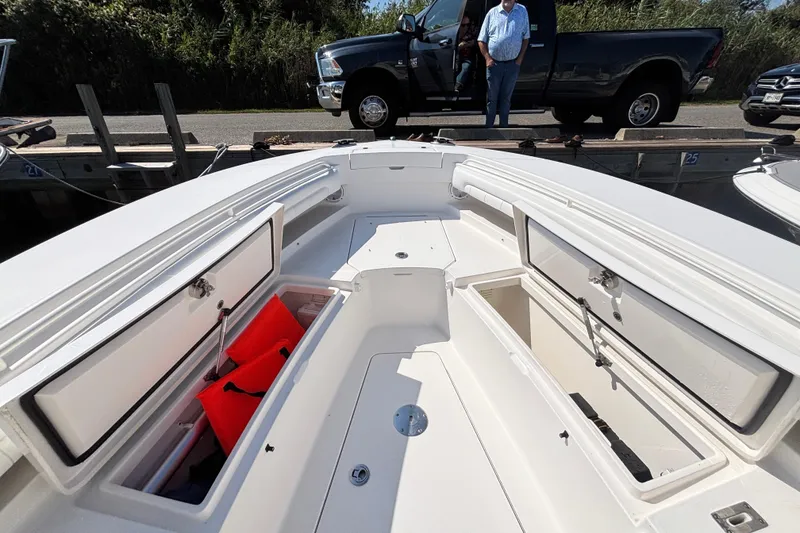 Slide: The Image of 2017 Regulator 28 boat with open storage compartments and visible life jackets. - 10