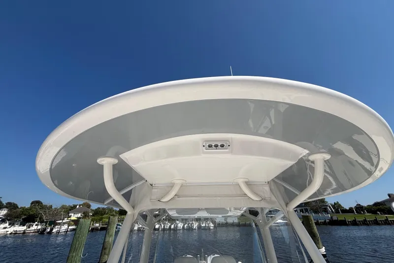 Slide: The Image of 2017 Regulator 28 boat's T-top against clear blue sky, dockside view. - 16