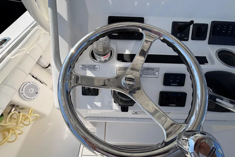 Slide: The Image of Steering wheel of a 2017 Regulator 28 boat with control panel and throttle. - 21