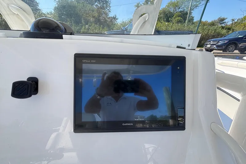 Slide: The Image of Garmin GPSMAP XSV on 2017 Regulator 28 boat dashboard, reflecting surroundings. - 24