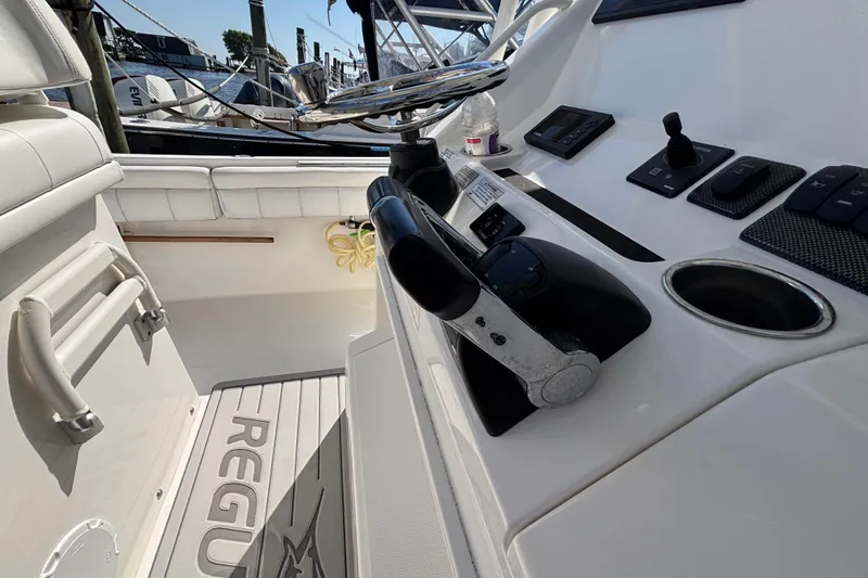 Slide: The Image of 2017 Regulator 28 boat cockpit with steering wheel and control panel. - 27