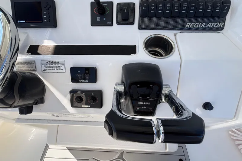 Slide: The Image of Control panel of a 2017 Regulator 28 boat with Yamaha throttle and switches. - 28