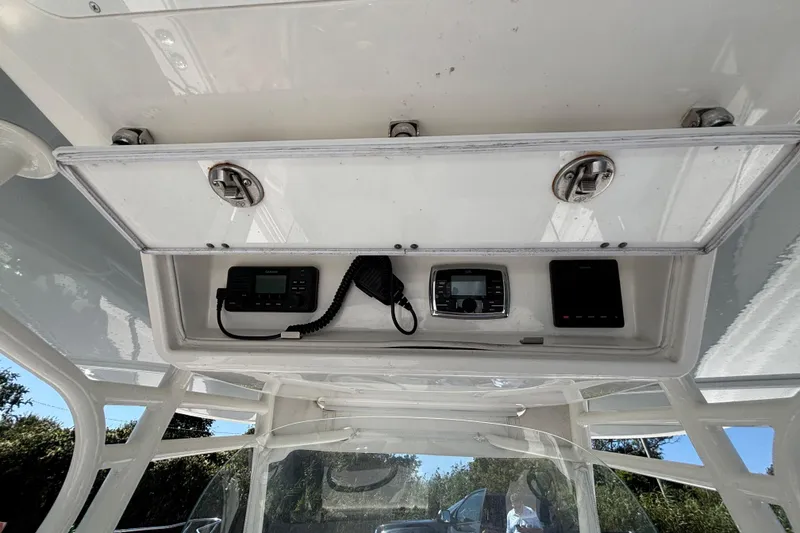 Slide: The Image of 2017 Regulator 28 boat console with electronic equipment and storage compartment. - 33