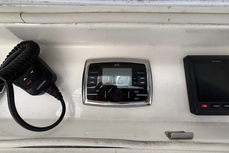 Slide: The Image of Control panel of a 2017 Regulator 28 boat featuring Garmin and Polk audio systems. - 36