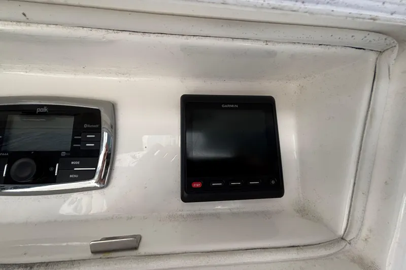 Slide: The Image of Control panel of a 2017 Regulator 28 boat featuring Garmin and Polk systems. - 37