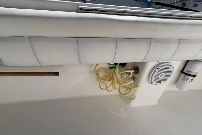 Slide: The Image of 2017 Regulator 28 boat interior with coiled hose, speaker, and fire extinguisher. - 38