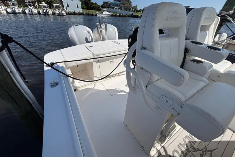 Slide: The Image of 2017 Regulator 28 boat interior with white seating and dual outboard motors. - 40
