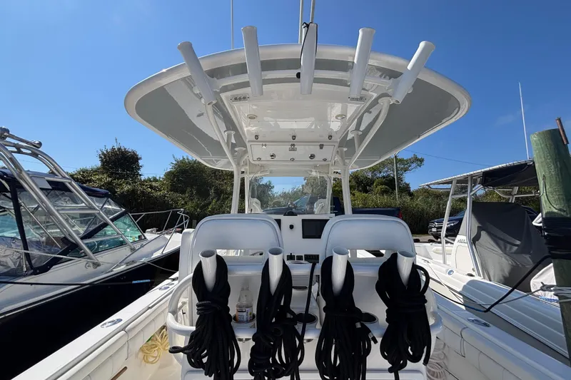 Slide: The Image of 2017 Regulator 28 boat interior with helm station and seating, docked under clear blue sky. - 41