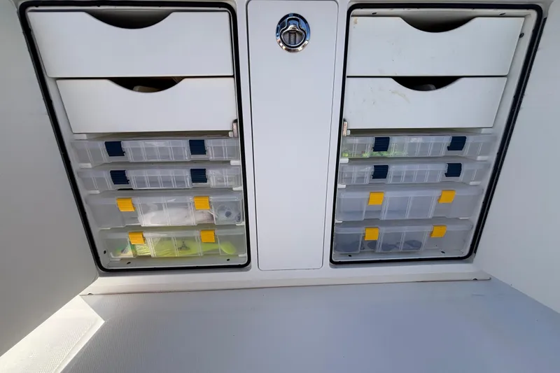 Slide: The Image of Storage compartments with tackle boxes on a 2017 Regulator 28 boat. - 42
