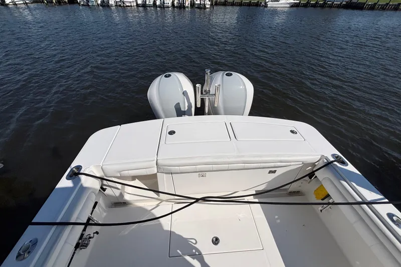 Slide: The Image of 2017 Regulator 28 boat with dual outboard motors on calm water. - 44