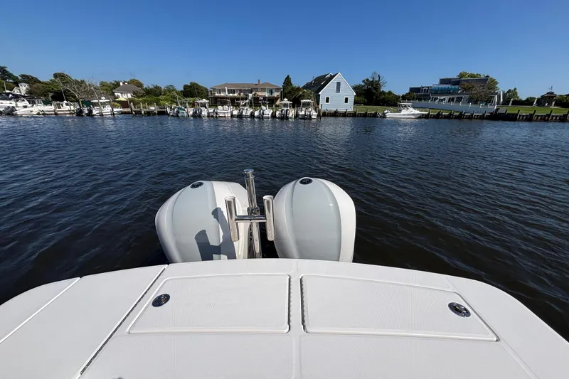 Slide: The Image of 2017 Regulator 28 boat with dual engines on a calm waterfront. - 46