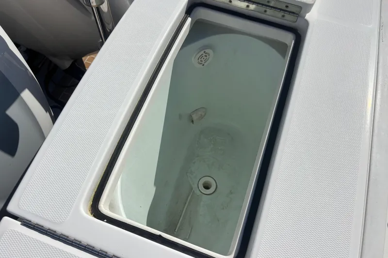 Slide: The Image of Livewell compartment on a 2017 Regulator 28 boat, featuring a clean interior. - 47