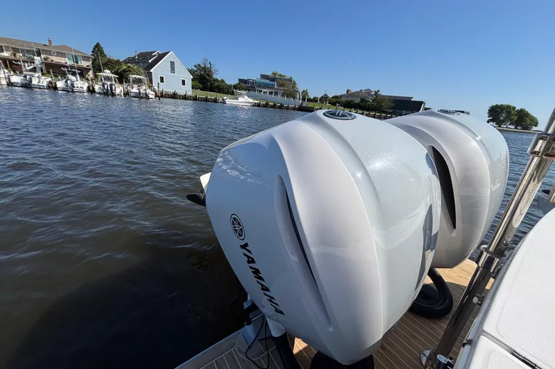 Slide: The Image of 2017 Regulator 28 boat with Yamaha outboard engines docked by waterfront homes. - 50
