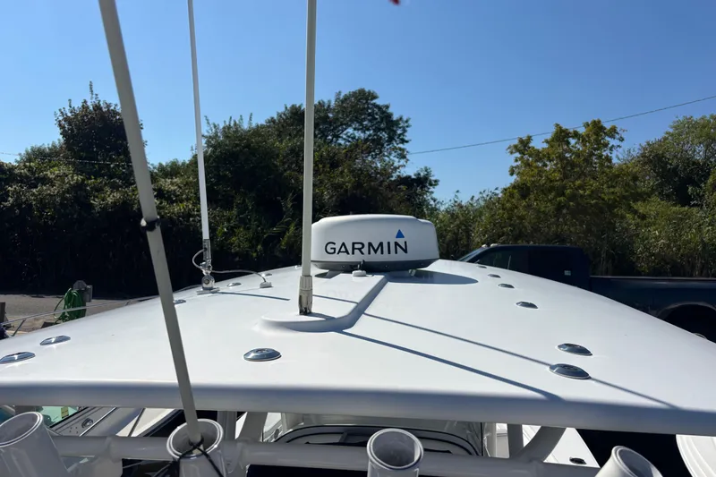Slide: The Image of 2017 Regulator 28 boat with Garmin radar, antennas, and clear sky background. - 52