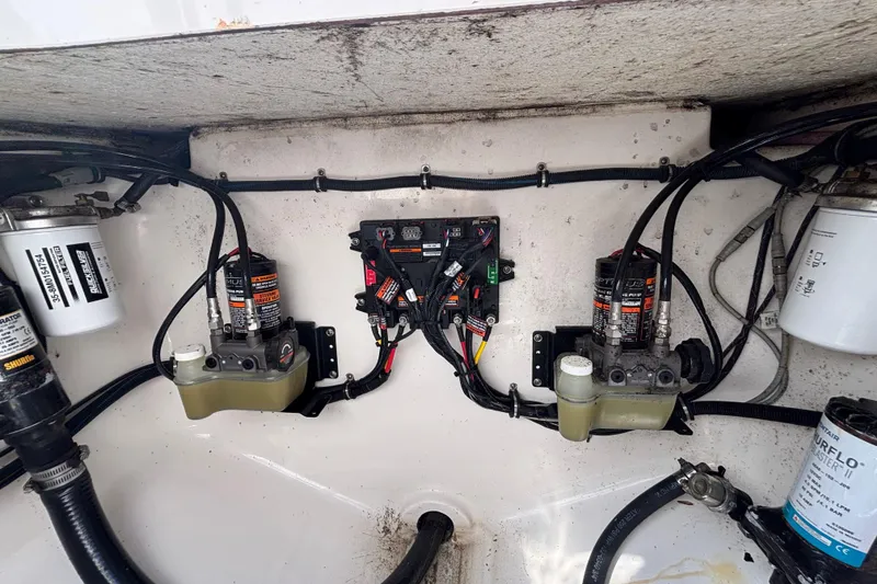 Slide: The Image of 2017 Regulator 28 boat engine compartment with wiring and hydraulic systems. - 56