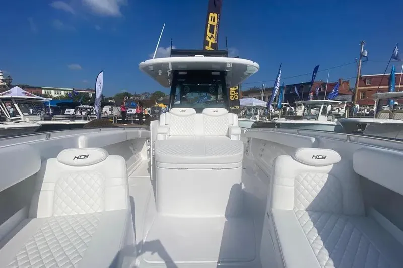 Slide: The Image of 2025 HCB 39 Speciale luxury boat with white seating and sleek design at a marina. - 15