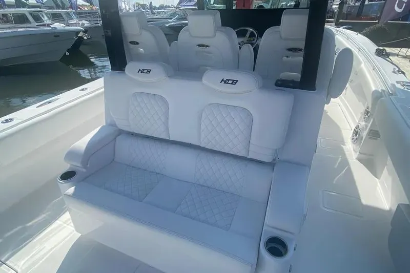 Slide: The Image of 2025 HCB 39 Speciale boat interior with luxurious white seating and cup holders. - 17