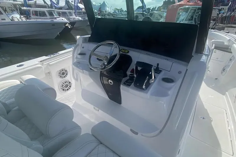 Slide: The Image of 2025 HCB 39 Speciale boat cockpit with steering wheel and controls. - 18