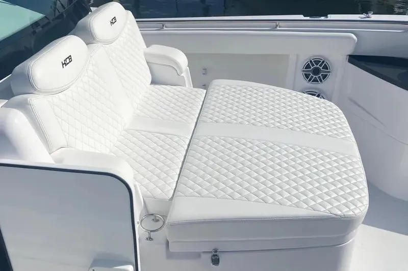 Slide: The Image of Luxurious white seating on 2025 HCB 39 Speciale boat with quilted design. - 4