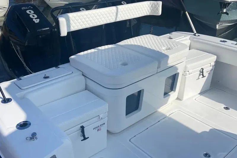 Slide: The Image of 2025 HCB 39 Speciale boat interior with cushioned seating and storage compartments. - 5