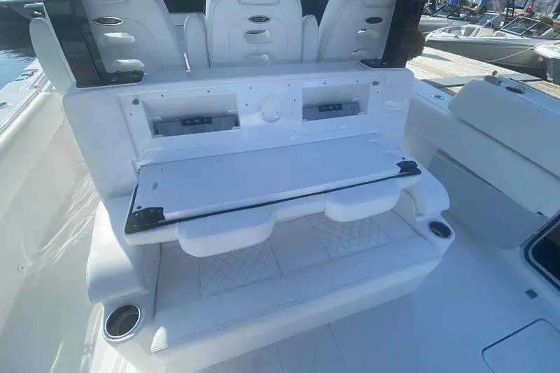 Slide: The Image of 2025 HCB 39 Speciale boat interior with white seating and storage compartments. - 9